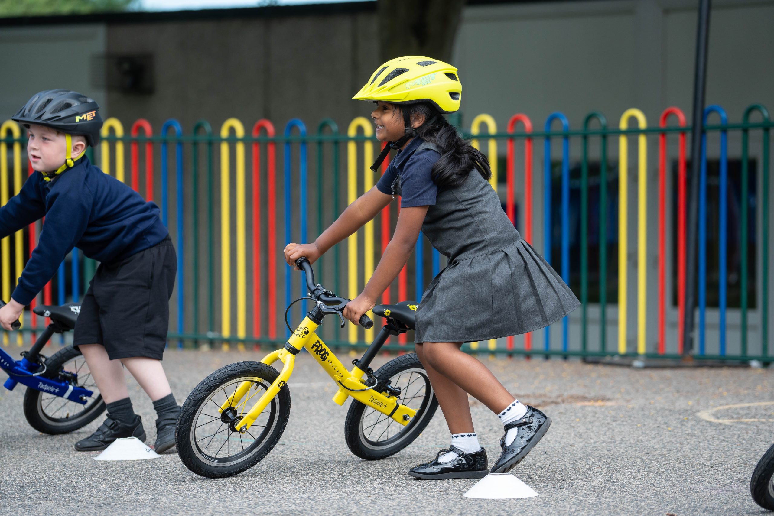 Little girl with a yellow bike during a bikeability session